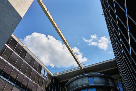Modern buildings under blue sky with white clouds