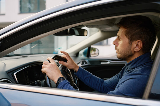 Man driving car during daytime commute
