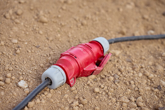 Power Cable Connector Lying on Dirt at Outdoor Work Site