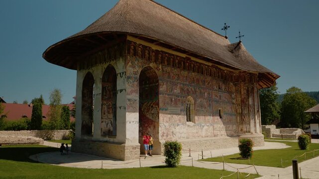 Explore Humor Monastery in Bucovina, Romania. Discover the rich art of old paintings on the walls while taking in the surrounding nature and architecture.