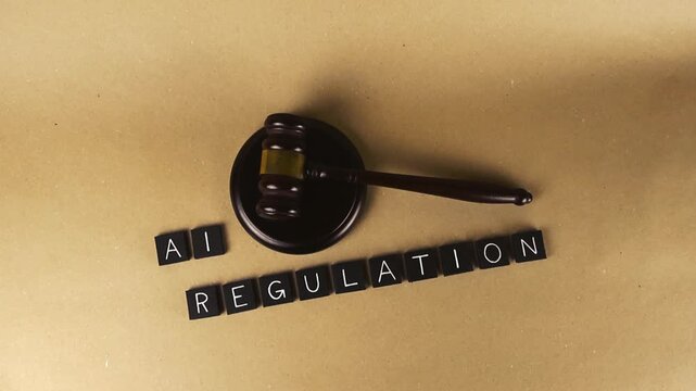 Top down view highlighting the concept of AI regulation, featuring a judge's gavel next to letter tiles spelling out the words, symbolizing new laws and legal frameworks for technology