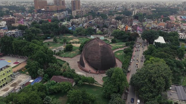Aerial drone view of Golghar, a massive dome-shaped historic granary in Patna, Bihar, India. The iconic 18th-century monument is surrounded by lush greenery and the urban landscape of Patna