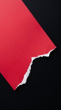 Torn Red Paper Corner Against Dark Background