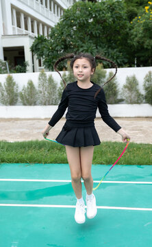 Young girl jumping rope outdoors