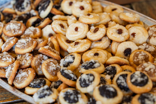 Close up of traditional Czech sweet wedding kolache pastries filled with poppy seed, plum jam and quark cheese on a silver serving tray.