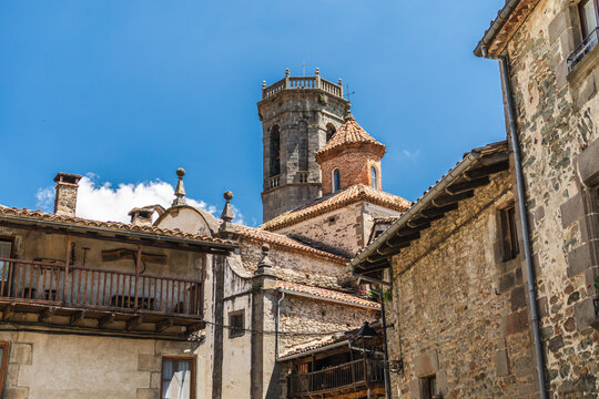 Traditional wooden gate set within stone masonry facade in Rupit village, Catalonia, Spain, showcasing handcrafted timber construction