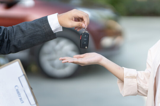 lease, rental car, sell, buy. Dealership manager send car keys to the new owner. Sales, loan credit financial, rent vehicle, insurance,  renting, Seller, dealer, installment, car care business