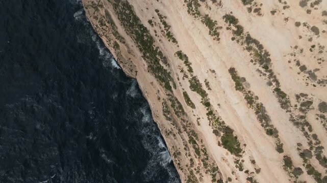 Aerial Drone Reveal of Rocky Coastal Cliffs and Blue Sea Landscape, Dingli, Malta