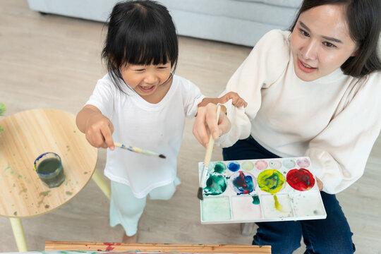 Mother day, Happy Asia mother play and learn drawing for little girl. Funny family is happy and excited in the house. Mother and daughter  having fun spending time together. Holiday, Activity