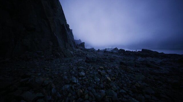 ethereal rocky ravine before dawn, silent cliffs and pebblestrewn slope shrouded in pale blue fog soft cool light and gentle mist create contemplative mood,