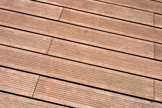 Dark brown composite wooden deck flooring planks.