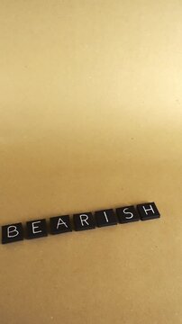 Black letter tiles spelling the word BEARISH on a light brown background, representing a financial concept of pessimism and falling stock prices in a declining market or recession