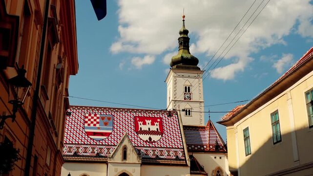 ZAGREB, CROATIA - JULY 12 2017: Church of St. Mark is parish church of old Zagreb, Croatia, located in St. Mark's Square. Coat of arms of Triune Kingdom of Croatia, Slavonia, and Dalmatia, and city