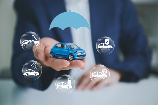 Car insurance coverage with businessperson holding model car to represent accident protection roadside assistance vehicle repair financial security risk management and automotive support.