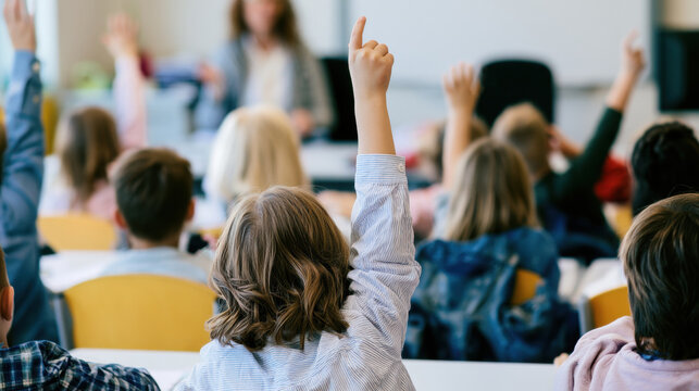 Students raise their hands during a lesson in a classroom setting in a school