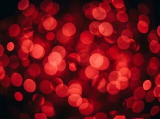 Fototapeta premium Out of focus glowing red festive lights creating bokeh circles for holiday backgrounds and celebratory atmosphere.