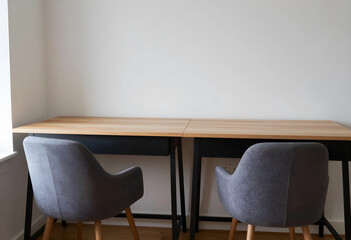 Fototapeta premium Home office setup for remote work, modern minimalist workspace with two empty chairs and wooden desks against a white wall
