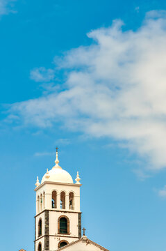Church of Santa Ana Bell Tower With Dome And Cross Against Blue Sky