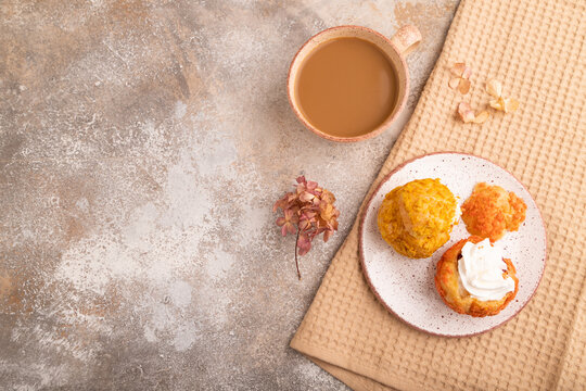 Сhoux pastry cake with cup of coffee on brown concrete, copy space, top view.