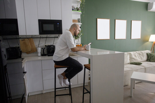 Pensive Man reading online book on digital tablet pc using e reader app.