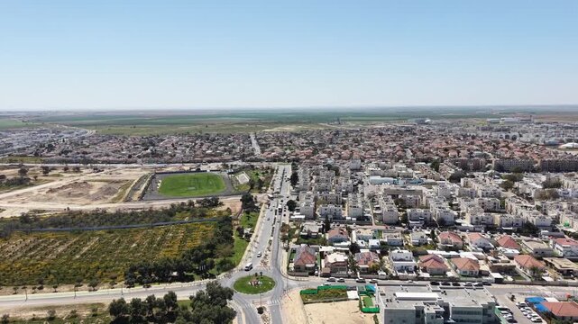 Aerial drone view of Ofakim city and industrial area in southern Israel with urban landscape and infrastructure