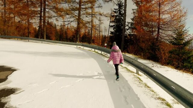 Little beautiful girl in pink jacket walks in High Tatras mountain, eastern Slovakia.