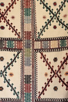 A detail of a kilim featuring traditional motifs. An example of the Turkish art of hand-weaving, showcasing geometric and floral patterns.