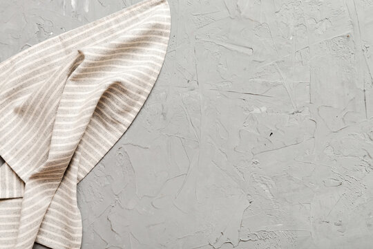 top view with gray kitchen napkin isolated on table background. Folded cloth for mockup with copy space, Flat lay. Minimal style