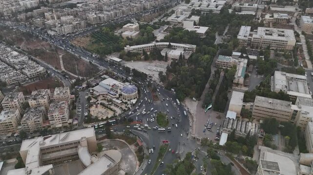 Drone view of a city landscape in Aleppo, Syria. Urban skyline and residential neighborhoods from above. City streets, infrastructure, and middle eastern architecture.
