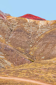 Peru, South America: aerial view of Palccoyo rainbow mountain, a mountain range in the Andes, 5.000 meters above sea level, with colourful stripes caused by natural mineral and clay weathering