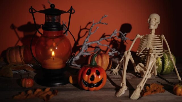 Camera glide past candle lantern, pumpkin and skeleton decor for Halloween party backdrops, spooky autumn interiors and seasonal design