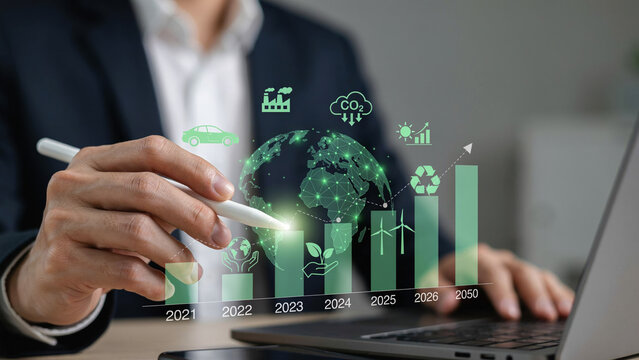 Businessman sustainability graph technology carbon renewable energy growth laptop hand Businessman hand using pen with sustainability graph, carbon icon, renewable energy symbol, global ecology