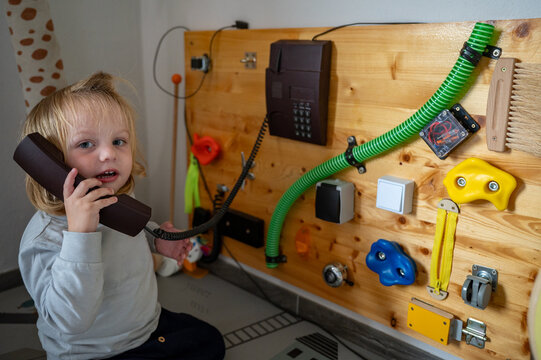 Toddler Exploring a Sensory Board with Real-Life Objects &ndash; Montessori-Inspired Learning, Fine Motor Skills and Child Development