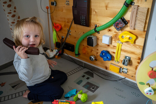 Toddler Exploring a Sensory Board with Real-Life Objects &ndash; Montessori-Inspired Learning, Fine Motor Skills and Child Development
