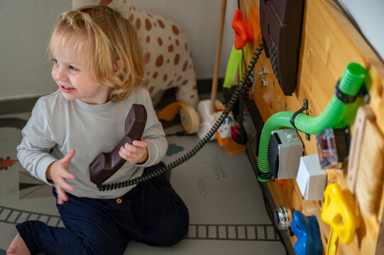 Toddler Exploring a Sensory Board with Real-Life Objects &ndash; Montessori-Inspired Learning, Fine Motor Skills and Child Development