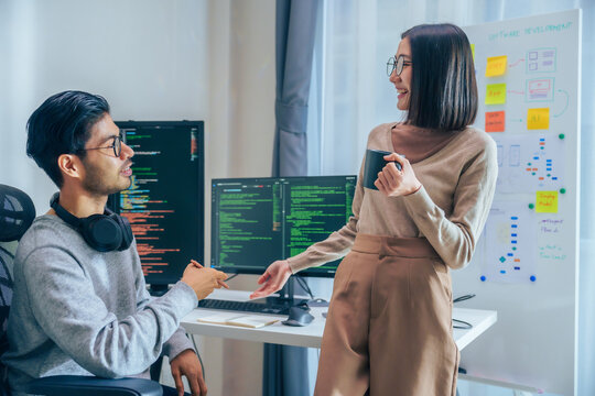 Two software developers engage in a discussion at coffee break time in a modern office, relax emotion