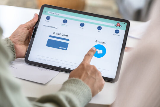 close up Couple using tablet and credit card to shop online through e-commerce app, making payment and browsing modern platform with promo codes and discount offers