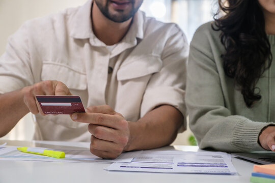 Couple using credit card pay the bill online shopping, making payment and browsing modern platform.