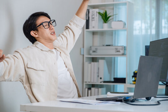 Tired programmer suffering stress and burnout while working at office on software development task