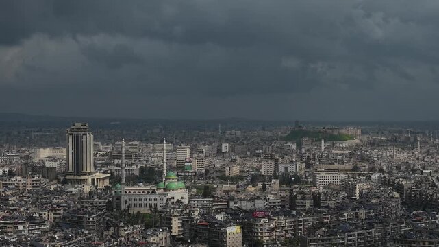 Drone view of a city landscape in Aleppo, Syria. Urban skyline and residential neighborhoods from above. City streets, infrastructure, and middle eastern architecture.