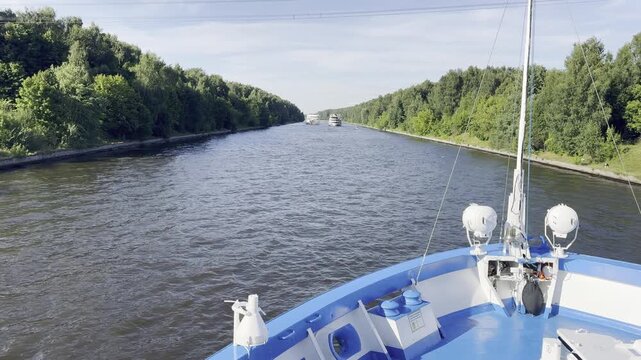 Volga River, Volga-Don Canal, Russia, August 7, 2026, view from the bow of a riverboat as passenger cruise ships follow one another along the canal.