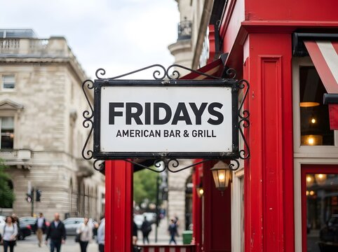 Exterior view of a fridays restaurant with a classic sign in london