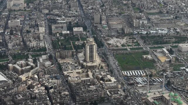 Drone view of a city landscape in Aleppo, Syria. Urban skyline and residential neighborhoods from above. City streets, infrastructure, and middle eastern architecture.