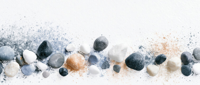 natural stone pebble texture gradient scattering across pale negative space evokes organic wellness authenticity for spa branding web design advertising and editorial layout use
