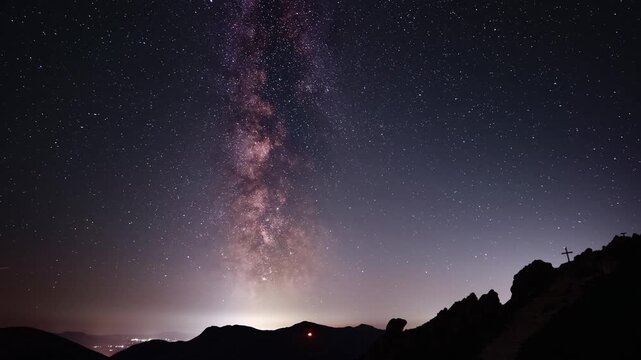 Milky Way Timelapse Over Mountain Silhouette With Summit Cross