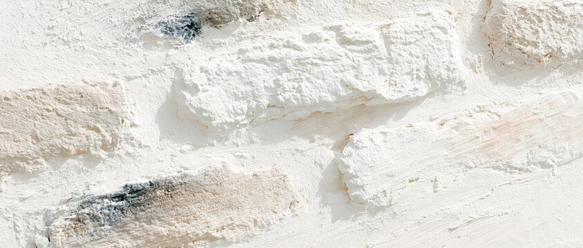 weathered whitewashed brick wall texture with peeling plaster and rustic patina for authentic sustainable interior design web banners advertising backgrounds editorial layouts
