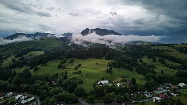 Aerial Hyperlapse Orbit Rural Mountain Village Between Thunderstorms Approaching Storm