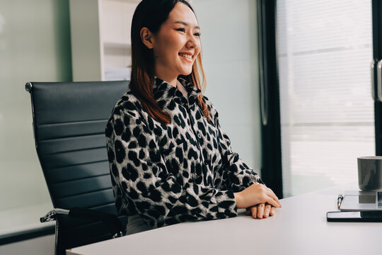Confident asian business woman standing in modern office