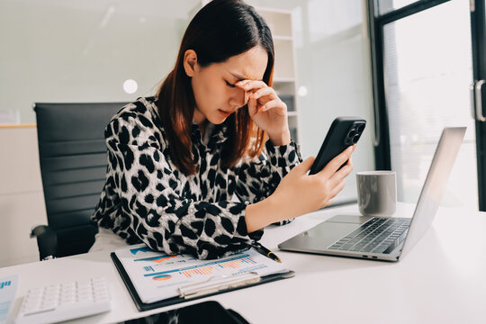 Tried young Asian office employee feeling sick and have a headache from a long working day at office