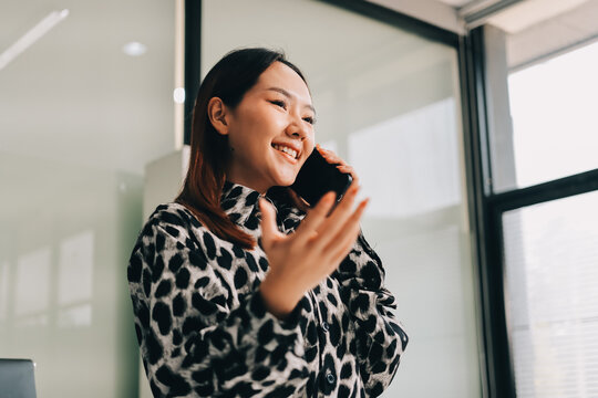 Confident asian business woman standing in modern office